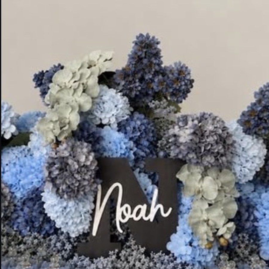 Floral arch with cut name sign