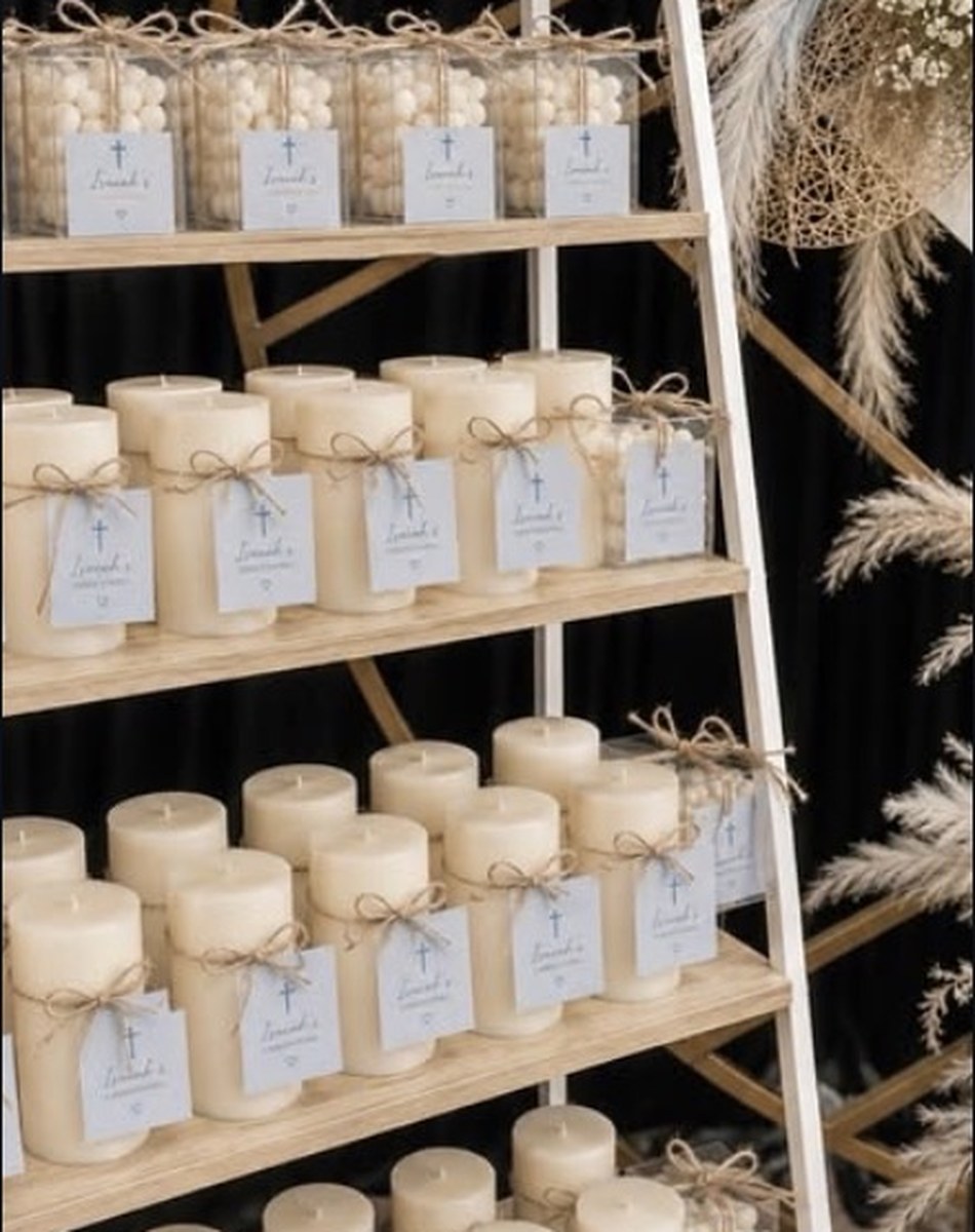Christening candle favours on a styled display ladder